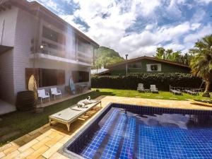 a house with a swimming pool next to a house at Casarão do Coronel - Descanso e lazer em Maresias na Praia do Saco in Maresias