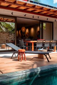 a picnic table and chairs next to a pool at Kasa Kanui Milagres in São Miguel dos Milagres +8 photos