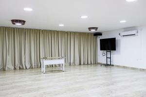 a room with a white piano and a screen at Posada Sueño Real in San Martín +23 photos