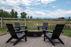 a couple of chairs sitting next to a fire pit at Golden Eagle Getaway w/Hot Tub! in Gallatin Gateway