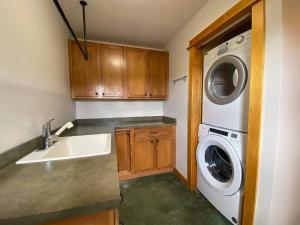 a kitchen with a sink and a washing machine at Golden Eagle Getaway w/Hot Tub! in Gallatin Gateway