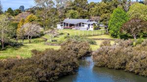 an aerial view of a house next to a river at The View at Kerikeri Inlet in Kerikeri