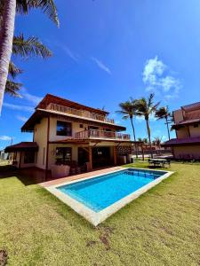 a house with a swimming pool in front of it at Casa Fortim Eco Village in Fortim