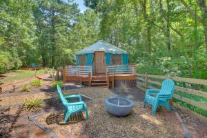 a gazebo with two chairs and a fire pit at Unplugged Retreat! Unique Yurt with Deck in Smokies in Smithville