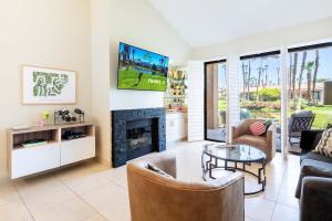 a living room with a fireplace and a tv at TWO Guest Suites ON Tee Box #2 Palm Valley Country Club with access to Tennis and Athletic Club Two on #2! in Palm Desert
