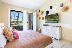 a bedroom with a bed and a tv on the wall at TWO Guest Suites ON Tee Box #2 Palm Valley Country Club with access to Tennis and Athletic Club Two on #2! in Palm Desert +53 photos