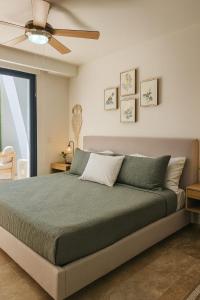 a bedroom with a bed and a ceiling fan at New Luxury Studio in the City Center in Playa del Carmen +74 photos