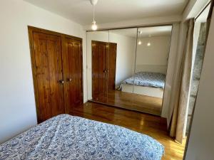 a bedroom with a bed and a large mirror at Casa do Octavia in Corvo