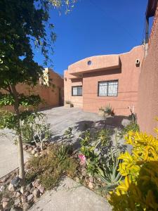 a house with a lot of flowers in front of it at Bonita Casa Centrica a 10 min del malecon in La Paz