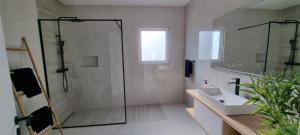 a bathroom with a glass shower and a sink at The Frenchie's House in Rabo de Peixe +5 photos