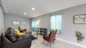 a living room with a leather couch and chairs at Unique Family Home in Denver in Denver