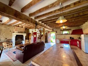 a large living room with a table and a kitchen at Gîtes avec piscine partagée dans la Brenne, proche sites historiques - FR-1-591-120 in Rosnay