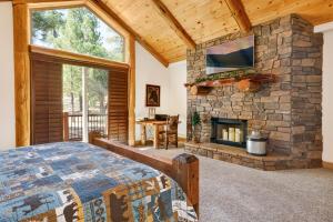 a bedroom with a stone fireplace and a bed at Luxury Heavenly Lodge Big Bear~ Hot Tub + Pool Table in Big Bear Lake