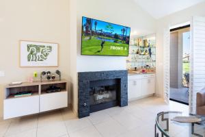 a living room with a fireplace and a flat screen tv at TWO Guest Suites ON Tee Box #2 Palm Valley Country Club with access to Tennis and Athletic Club Two on #2! in Palm Desert