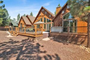 a large wooden house with a large deck at Luxury Heavenly Lodge Big Bear~ Hot Tub + Pool Table in Big Bear Lake