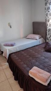 two beds sitting next to each other in a room at Pousada Aurora 3 in São Gabriel