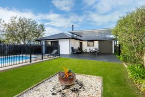 a backyard with a pool and a house at Pipers Spot - Pet Friendly - Fireplace with Swimming Pool in Culburra Beach