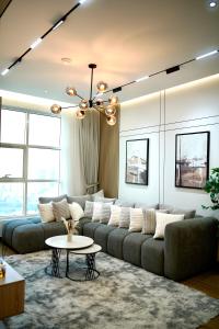 a living room with a couch and a table at Brand New 2 Bed Rooms , High-end Finishing in Ajman 