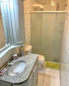 a bathroom with a sink and a toilet and a shower at Casa dei Nonni in Garibaldi +28 photos