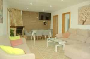 a living room with a couch and a table at casa vacacional con piscina privada in Sant Cebrià de Vallalta