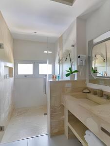 a bathroom with two sinks and a mirror at Caribbean Bright Dawn View 1BDRM Beachfront apt. in Juan Dolio
