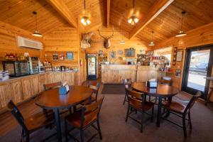 a dining room with two wooden tables and chairs at Bryce Canyon Inn in Tropic