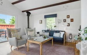 a living room with a blue couch and chairs at Pet Friendly Home In Haderslev With Wifi in Haderslev