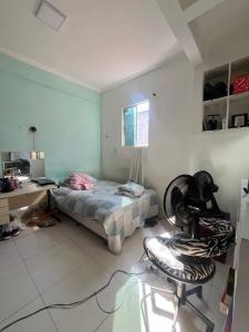 a bedroom with a bed and a desk and a chair at Casa Costa in Belém