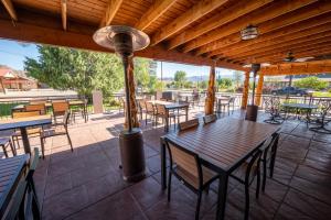 an outdoor patio with tables and chairs and a pole at Bryce Canyon Inn in Tropic