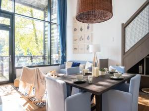 a dining room with a table and chairs at Waterside Elegance Sky Pad in Antoing