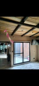 a room with a ceiling with a large window at Hogar viedmense in Viedma