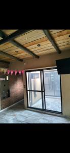 a room with a large glass door with a window at Hogar viedmense in Viedma +1 photo