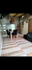 a dining room with a table and black chairs at Hogar viedmense in Viedma