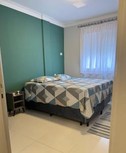 une chambre avec un lit et une fenêtre dans l'établissement Apartamento Lindo com sacada vista mar! Pé na areia!!!, à Guarujá