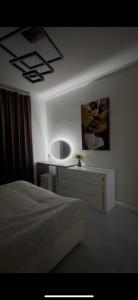 a bedroom with a bed and a mirror on the wall at A-Frame Yaşam in İsmayıllı +5 photos