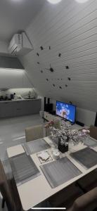 a room with a table with flowers and birds on the ceiling at A-Frame Yaşam in İsmayıllı