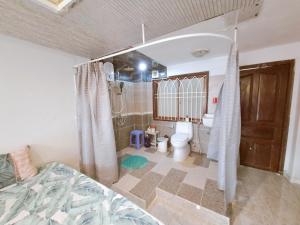 a bathroom with a bed and a toilet in a room at Homestay Hostel Apartment Minh Lộc in Ho Chi Minh City
