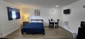 a bedroom with a bed and a table in it at Sunrise Inn LLC in Port Clinton