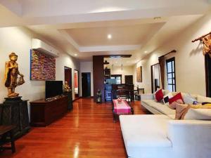 a living room with a couch and a table at Secure 3 Bedroom Villa near beach in Kamala Beach