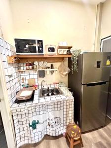 a toy kitchen with a sink and a refrigerator at Rock Reef Minimal Home in Ao Nang 