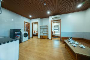 a living room with a table and a tv at Tuan Nam Hotel in Hai Phong