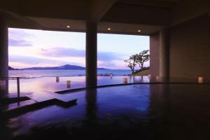 a swimming pool with a view of the ocean at TAOYA Shima in Toba