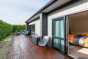 a house with a bedroom and a balcony with a bed at Forty-Five in Martinborough 