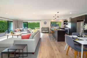 a living room and kitchen with a couch and a table at Forty-Five in Martinborough 