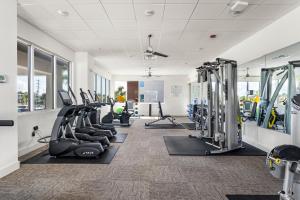un gimnasio con cintas de correr y máquinas de cardio en Blu 202 - Modern Oceanfront Luxury - Free Beach Service - Must See!, en Fort Walton Beach