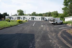a parking lot with a truck parked in front of a building at Rainbow Motel in Douglassville
