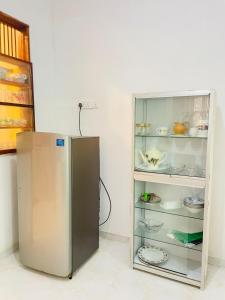 a refrigerator freezer sitting in a kitchen next to a wall at Kenashi Green Villa in Weligama +15 photos