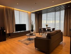 a living room with a couch and a table at OS Style Hotel Batam Centre in Batam Center