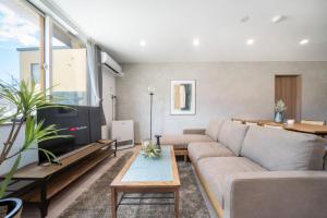 a living room with a couch and a tv at Mks 102 in Asahikawa +99 photos