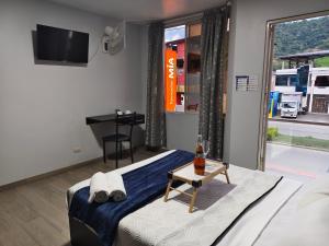 a bedroom with a bed and a table and a window at Hotel GM zamora Balcony in Zamora